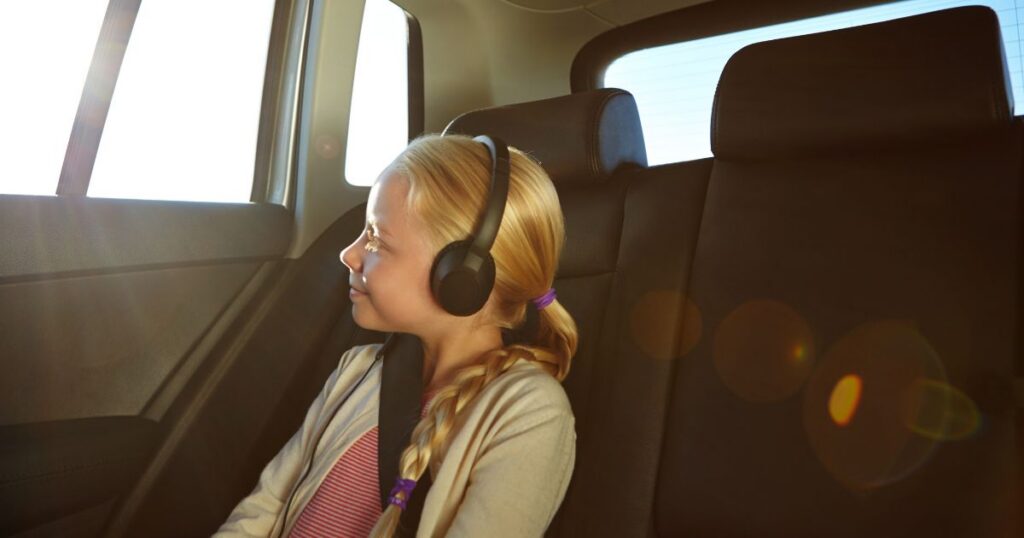 15 Screen-Free Car & Travel Activities for Long Summer Drives kids headphones in car